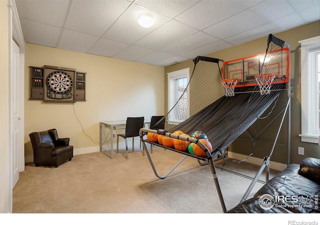 rec room with carpet flooring, a drop ceiling, and baseboards