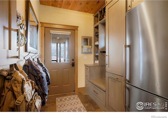 entryway featuring wooden ceiling and stone finish floor