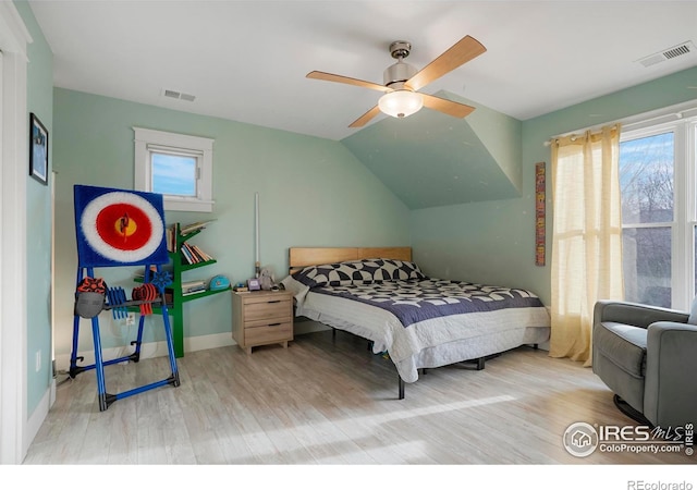 bedroom with visible vents, lofted ceiling, a ceiling fan, and light wood-style floors