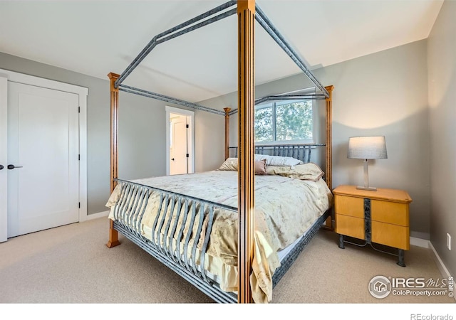 carpeted bedroom featuring baseboards