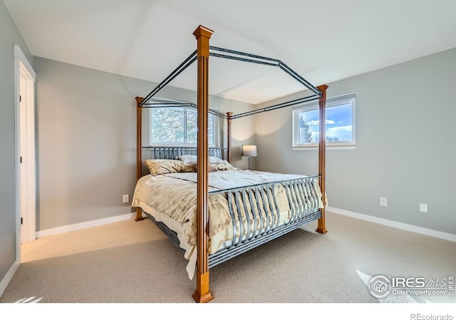 carpeted bedroom featuring baseboards