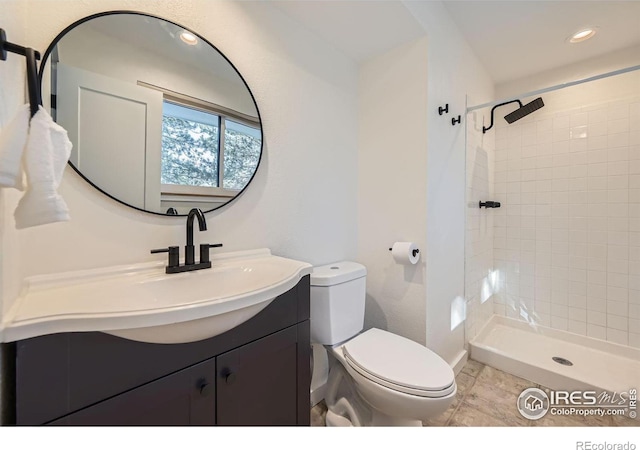 full bath with tile patterned flooring, toilet, a tile shower, recessed lighting, and vanity