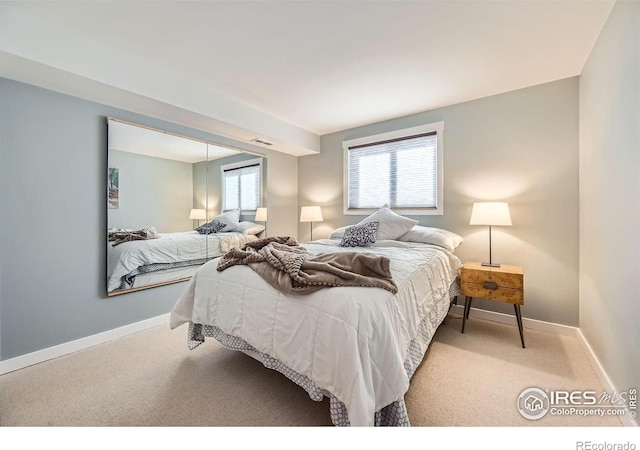 carpeted bedroom with visible vents and baseboards