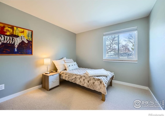 carpeted bedroom featuring baseboards