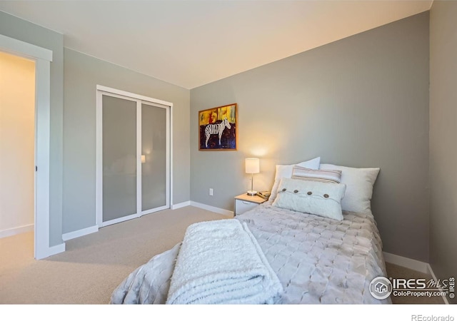 bedroom featuring a closet, baseboards, and carpet floors