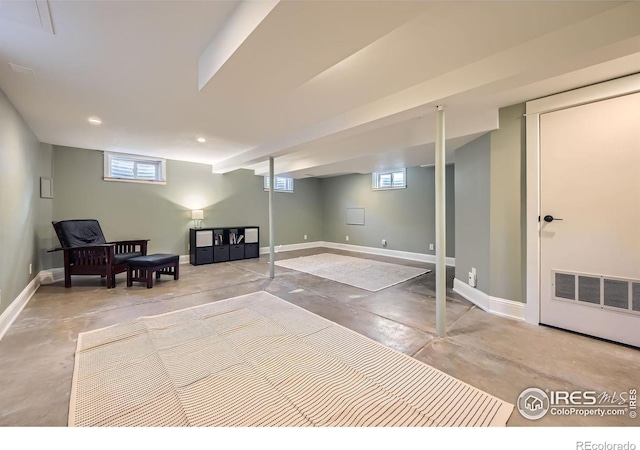 living area with recessed lighting, visible vents, baseboards, and finished concrete flooring