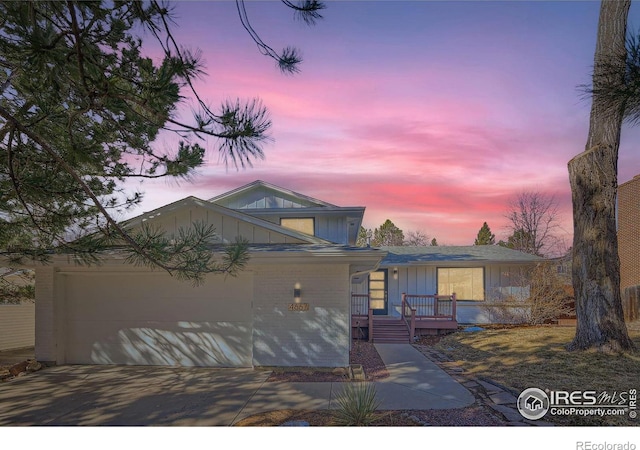 view of front of property with a garage, board and batten siding, and concrete driveway