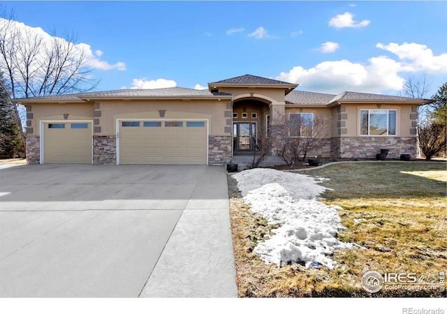 prairie-style house with a garage and a front yard