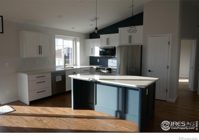 kitchen with stainless steel refrigerator with ice dispenser, dishwashing machine, hanging light fixtures, and white cabinets