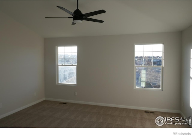 spare room featuring ceiling fan, vaulted ceiling, and carpet