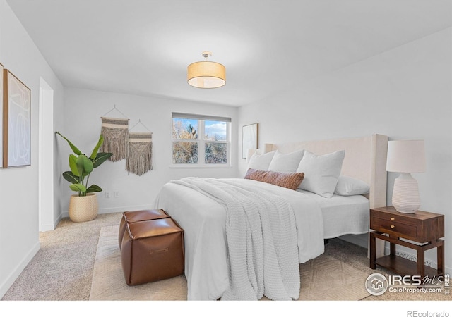 bedroom featuring light carpet