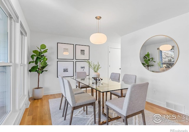 dining area with light hardwood / wood-style floors