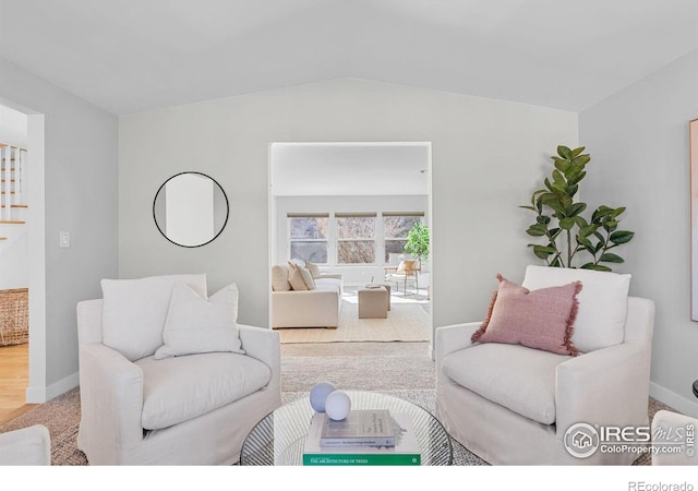 living room with lofted ceiling and carpet floors