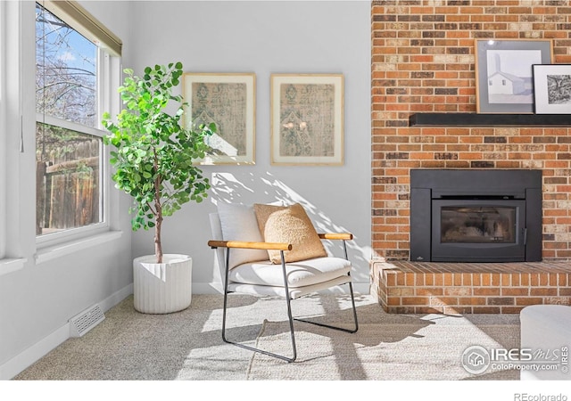 carpeted living room featuring a fireplace