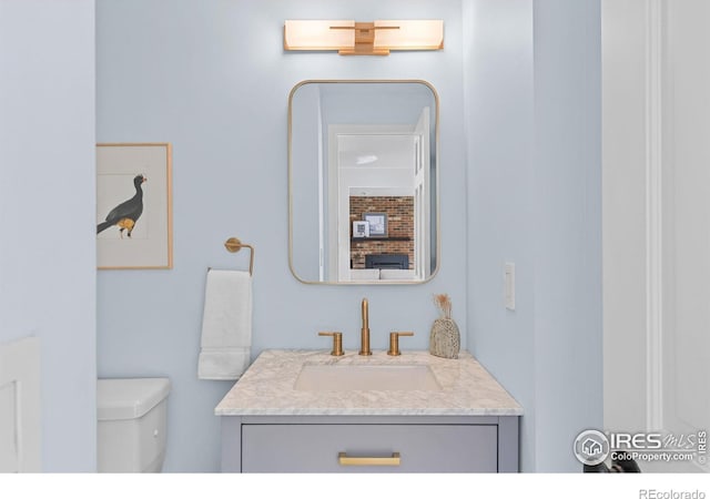 bathroom featuring vanity and toilet