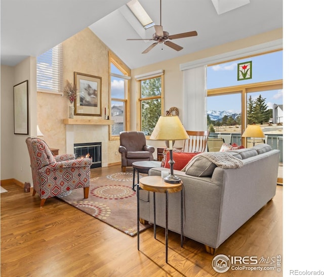 living room with hardwood / wood-style flooring, a healthy amount of sunlight, and a fireplace