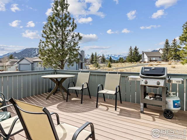 wooden deck featuring a grill and a mountain view