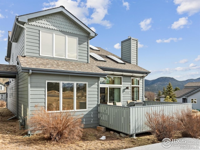 back of house with a mountain view