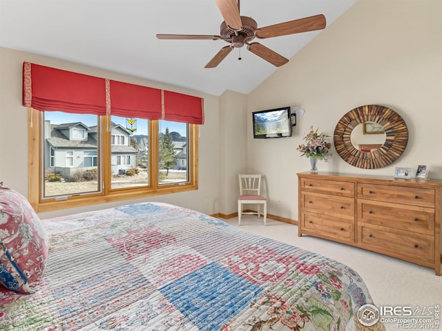 bedroom with vaulted ceiling, light colored carpet, and ceiling fan