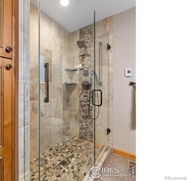 bathroom featuring a shower with shower door