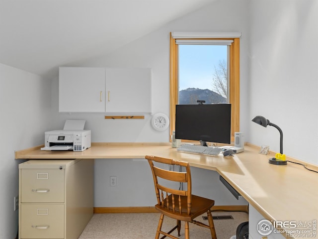 office area featuring built in desk and vaulted ceiling