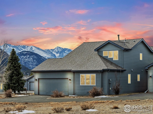 view of front facade featuring a mountain view and a garage