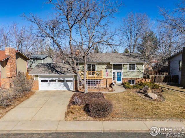 split foyer home featuring a garage and a front lawn