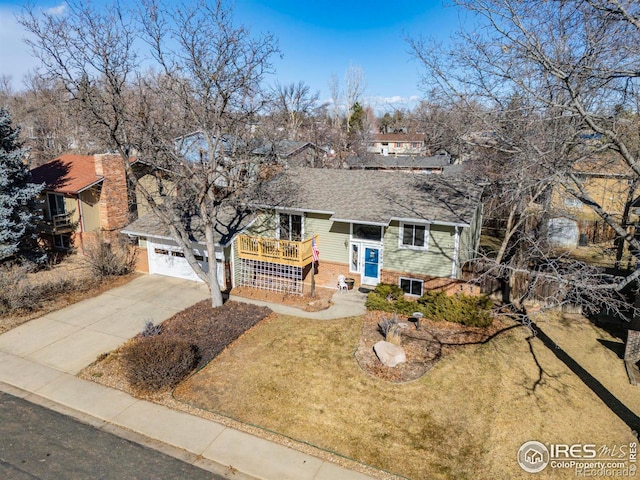 bi-level home featuring a garage and a front yard