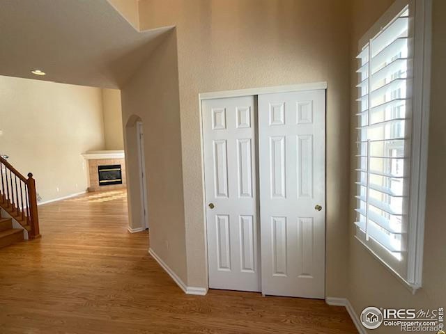 hallway featuring a healthy amount of sunlight and hardwood / wood-style floors