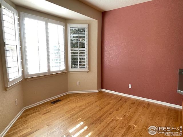 spare room with light hardwood / wood-style floors