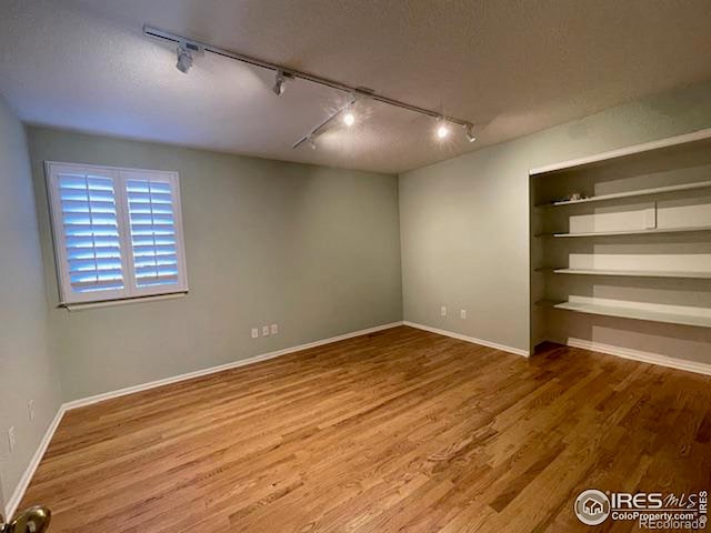 interior space with hardwood / wood-style floors and a textured ceiling