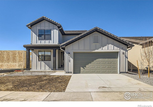 view of front of home featuring driveway, board and batten siding, an attached garage, and a tiled roof