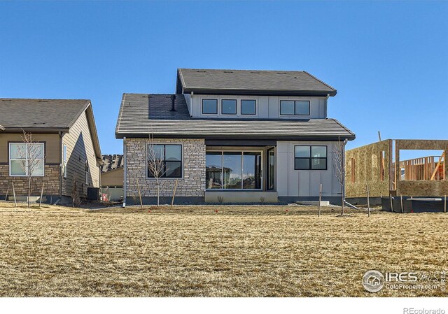 back of property featuring board and batten siding and central air condition unit