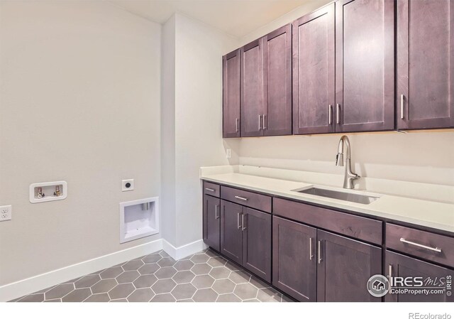 laundry area with washer hookup, a sink, baseboards, cabinet space, and electric dryer hookup