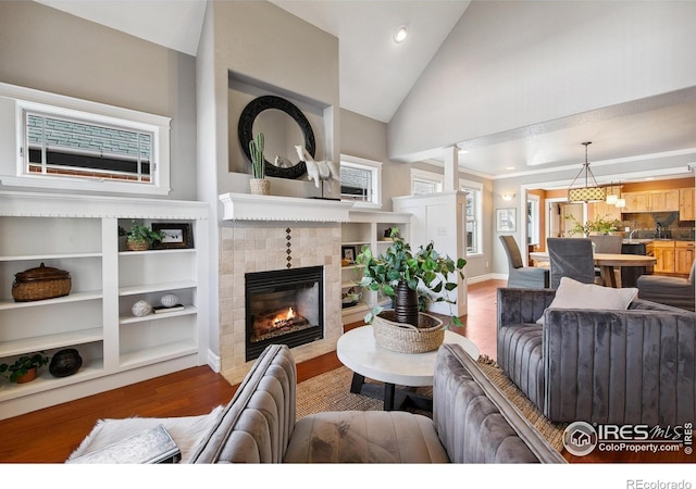 1005 Laporte Ave, Fort Collins, CO 80521 - living room with high vaulted ceiling, wood-type flooring, and a tile fireplace