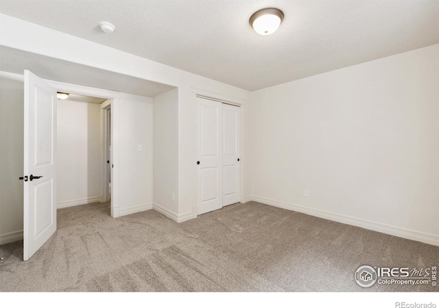 1005 Laporte Ave, Fort Collins, CO 80521 - unfurnished bedroom with light colored carpet, a closet, and a textured ceiling