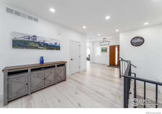 corridor with light hardwood / wood-style floors