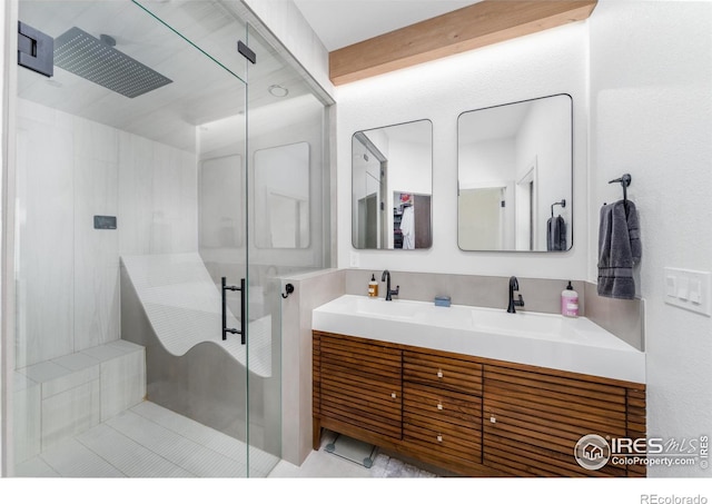 bathroom with vanity and a shower with door