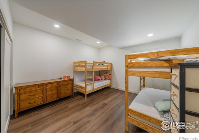 bedroom with dark hardwood / wood-style floors