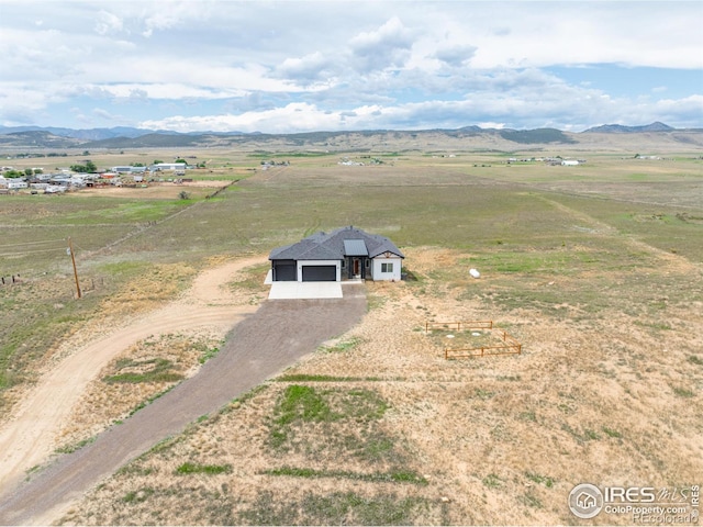 drone / aerial view with a mountain view and a rural view