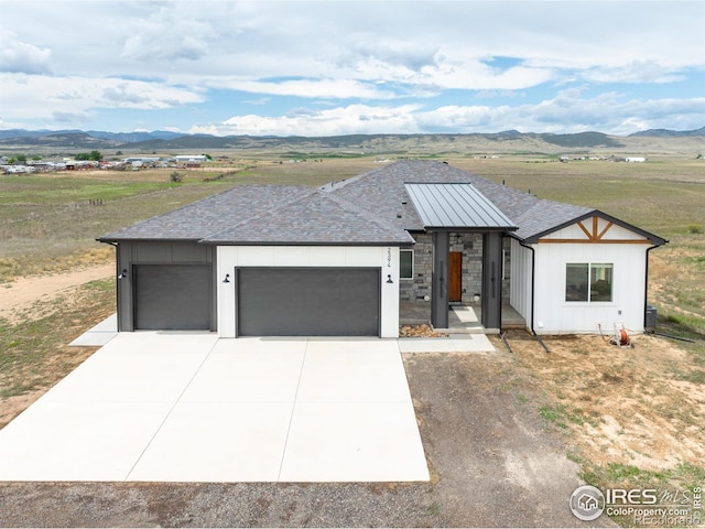 view of front of house featuring a garage and a mountain view