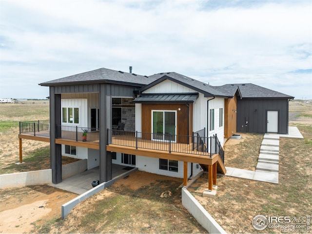 back of property featuring a deck and a patio area