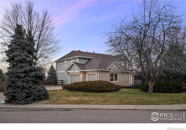 view of property with a yard and a garage