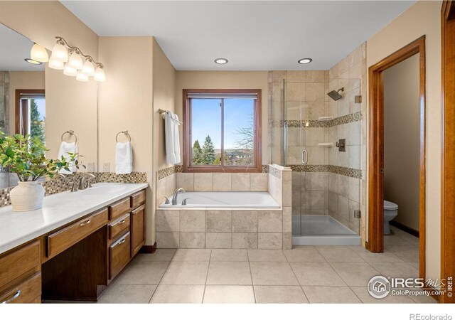 full bathroom with separate shower and tub, a wealth of natural light, tile patterned floors, and vanity