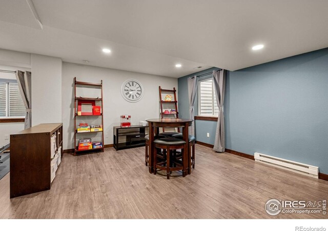 dining room with light hardwood / wood-style floors and a baseboard radiator