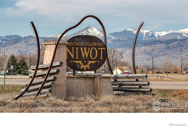 community sign with a mountain view