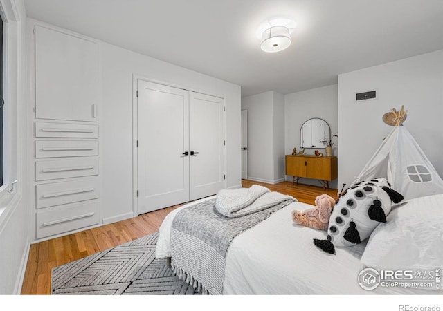 bedroom with a closet and light wood-type flooring