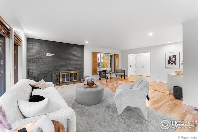 living room featuring wood-type flooring and a fireplace