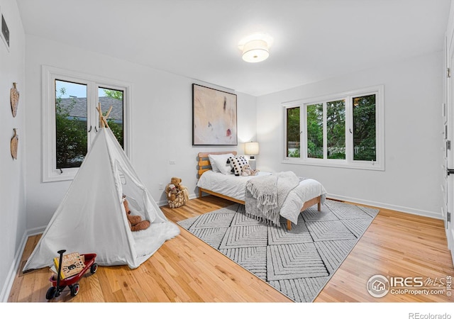 bedroom with wood-type flooring