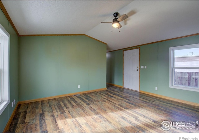 spare room with crown molding, hardwood / wood-style flooring, ceiling fan, a textured ceiling, and vaulted ceiling